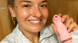 Close up of Daisy Kelliher smiling and holding VUSH Empress 2 clitoral suction vibrator
