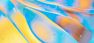 Close up digital illustration of blue, yellow, orange and pink thick liquid