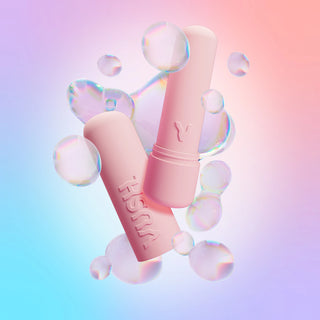 Gloss bullet vibrator and case in Pink Friday colourway displayed amongst digital iridescent bubbles against pink/blue/purple gradient background