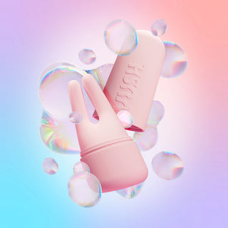 Swish dual tip vibrator and case in Pink Friday colourway displayed amongst digital iridescent bubbles against pink/blue/purple gradient background