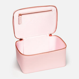 Pink hard storage case with open rose gold zip to display inside of bag with inside zip, against light grey background