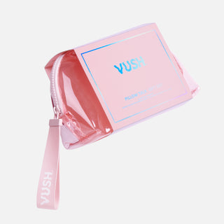 Clear pink case with zipper and tag that reads "VUSH" wrapped in paper packaging that reads "VUSH PILLOW TALK GIFT SET"